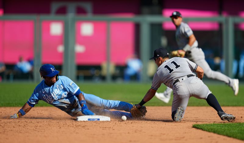 Oct 1, 2023; Kansas City, Missouri, USA; Kansas City Royals center fielder Dairon Blanco (44) steals second base as New York Yankees shortstop Anthony Volpe (11) is unable to make the catch during the sixth inning at Kauffman Stadium. Mandatory Credit: Jay Biggerstaff-USA TODAY Sports