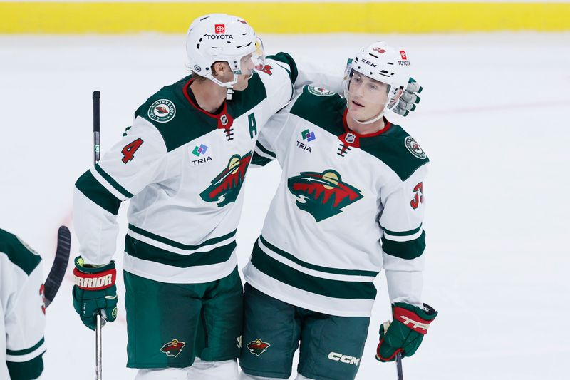 Sep 21, 2024; Winnipeg, Manitoba, CAN; Minnesota Wild Forward Ben Jones (39) celebrates his third period goal with Minnesota Wild defenseman Jon Merrill (4) against the Winnipeg Jets at Canada Life Centre. Mandatory Credit: James Carey Lauder-Imagn Images