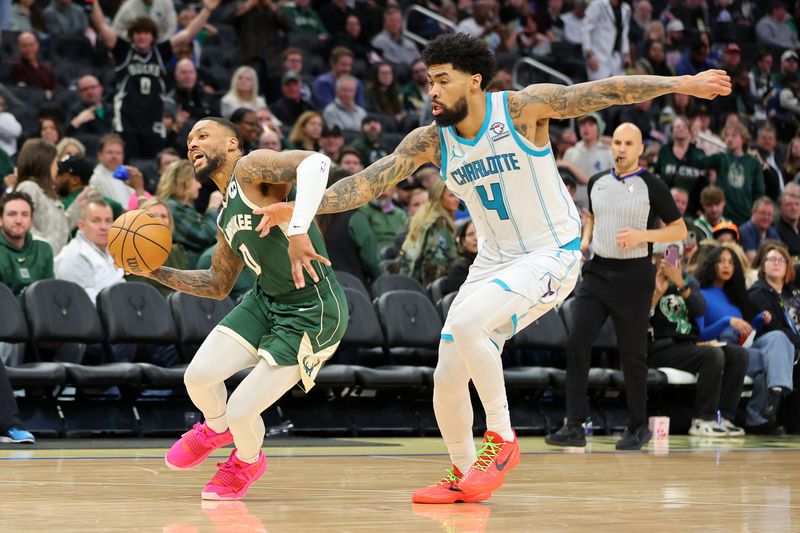 MILWAUKEE, WISCONSIN - FEBRUARY 09: Damian Lillard #0 of the Milwaukee Bucks is defended by Nick Richards #4 of the Charlotte Hornets during a game at Fiserv Forum on February 09, 2024 in Milwaukee, Wisconsin. NOTE TO USER: User expressly acknowledges and agrees that, by downloading and or using this photograph, User is consenting to the terms and conditions of the Getty Images License Agreement. (Photo by Stacy Revere/Getty Images)