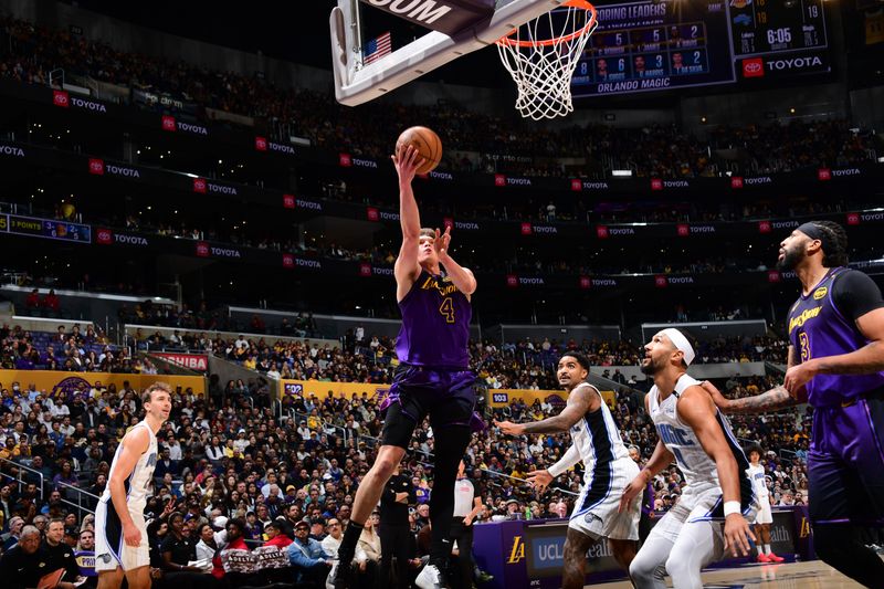 LOS ANGELES, CA - NOVEMBER 21: Dalton Knecht #4 of the Los Angeles Lakers drives to the basket during the game against the Orlando Magic on November 21, 2024 at Crypto.Com Arena in Los Angeles, California. NOTE TO USER: User expressly acknowledges and agrees that, by downloading and/or using this Photograph, user is consenting to the terms and conditions of the Getty Images License Agreement. Mandatory Copyright Notice: Copyright 2024 NBAE (Photo by Adam Pantozzi/NBAE via Getty Images)