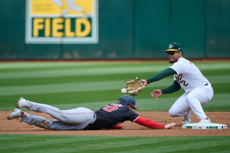 Apr 14, 2024; Oakland, California, USA; Washington Nationals outfielder Jacob Young (30) slides into second base on a pickoff play against Oakland Athletics shortstop Darell Hernaiz (2) during the first inning at Oakland-Alameda County Coliseum. Mandatory Credit: Robert Edwards-USA TODAY Sports