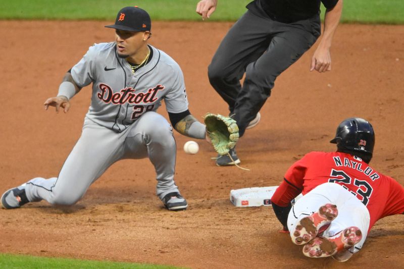 Jul 24, 2024; Cleveland, Ohio, USA; Cleveland Guardians catcher Bo Naylor (23) steals second base beside Detroit Tigers shortstop Javier Baez (28) in the eighth inning at Progressive Field. Mandatory Credit: David Richard-USA TODAY Sports