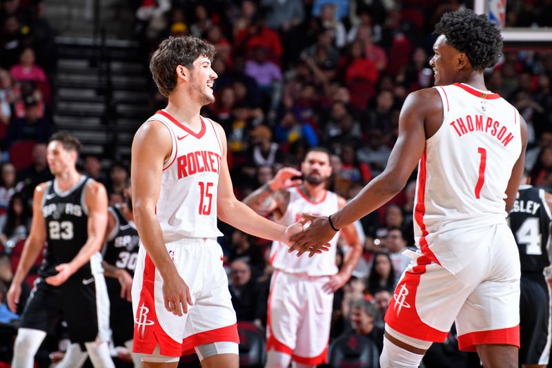 HOUSTON, TX - OCTOBER 17: Amen Thompson #1 and Reed Sheppard #15 of the Houston Rockets high five during the game against the San Antonio Spurs on October 17, 2024 at the Toyota Center in Houston, Texas. NOTE TO USER: User expressly acknowledges and agrees that, by downloading and or using this photograph, User is consenting to the terms and conditions of the Getty Images License Agreement. Mandatory Copyright Notice: Copyright 2024 NBAE (Photo by Logan Riely/NBAE via Getty Images)