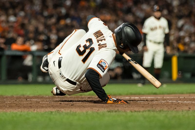 Sep 27, 2023; San Francisco, California, USA; San Francisco Giants first baseman LaMonte Wade Jr. (31) falls to the ground after getting hit the game against the San Diego Padres at Oracle Park. Mandatory Credit: John Hefti-USA TODAY Sports