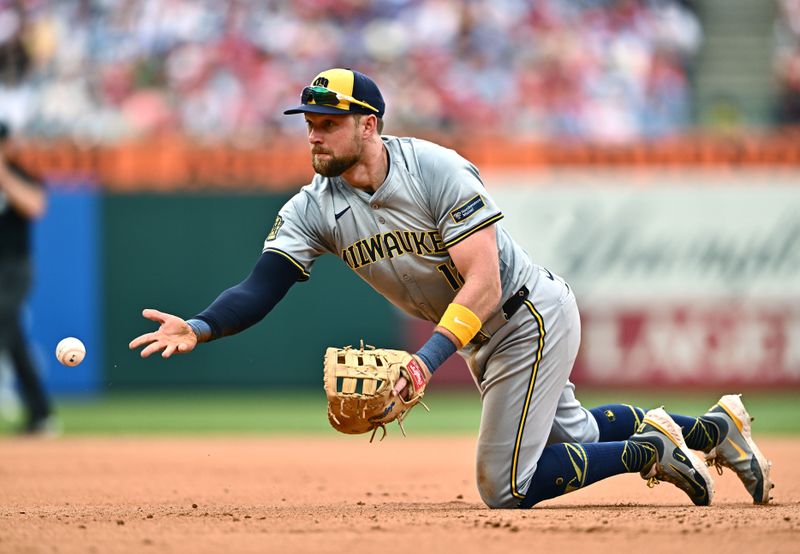 Jun 5, 2024; Philadelphia, Pennsylvania, USA; Milwaukee Brewers first baseman Rhys Hoskins (12) throws to first base against the Philadelphia Phillies in the seventh inning at Citizens Bank Park. Mandatory Credit: Kyle Ross-USA TODAY Sports