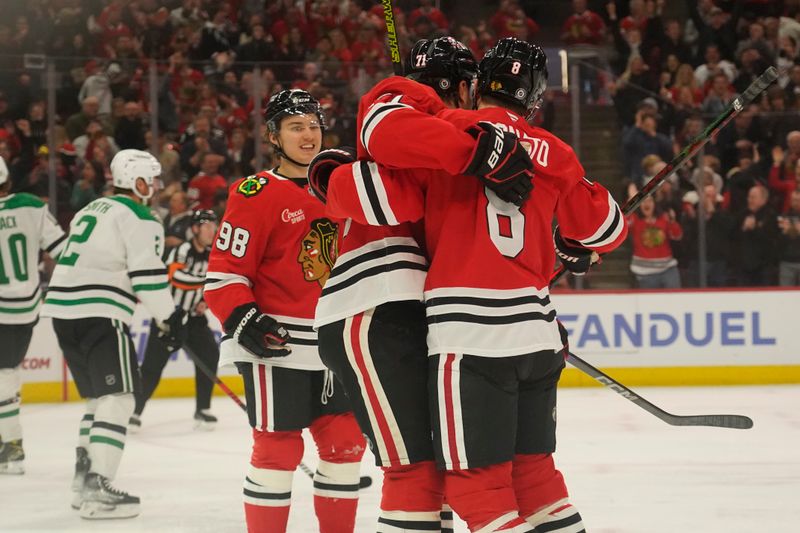 Nov 27, 2024; Chicago, Illinois, USA; Chicago Blackhawks left wing Taylor Hall (71) celebrates his second goal against the Dallas Stars with center Connor Bedard (98) and  center Ryan Donato (8) during the first period at United Center. Mandatory Credit: David Banks-Imagn Images