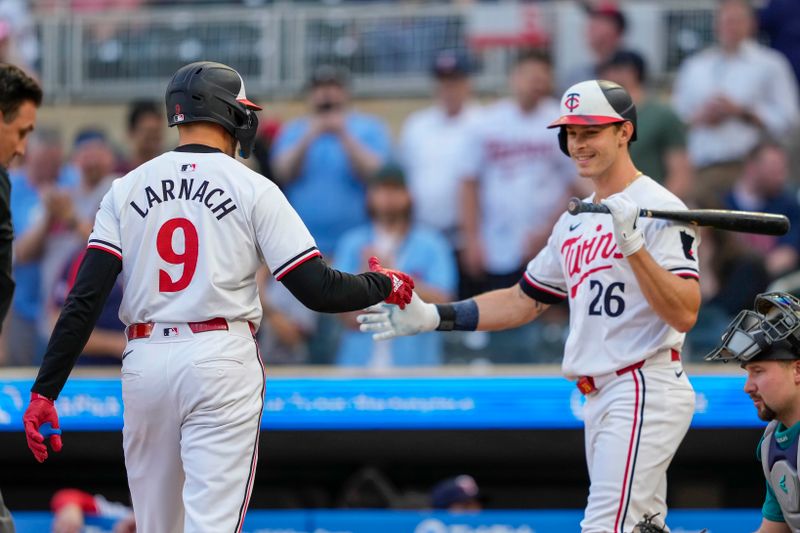May 8, 2024; Minneapolis, Minnesota, USA; Minnesota Twins designated hitter Trevor Larnach (9) celebrates with right fielder Max Kepler (26) after hitting a solo home run against the Seattle Mariners in the first inning at Target Field. Mandatory Credit: Jesse Johnson-USA TODAY Sports