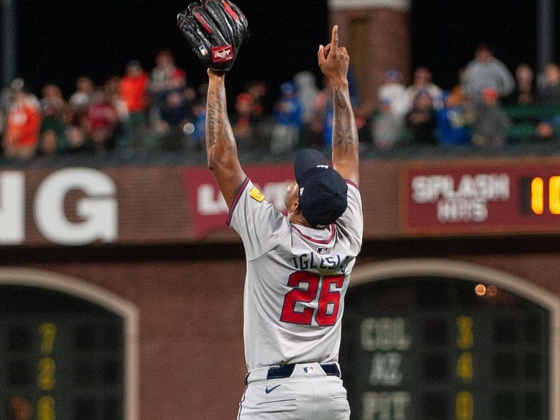 Aug 13, 2024; San Francisco, California, USA;  Atlanta Braves pitcher Raisel Iglesias (26) points to the sky after defeating the San Francisco Giants at Oracle Park. Mandatory Credit: Ed Szczepanski-USA TODAY Sports