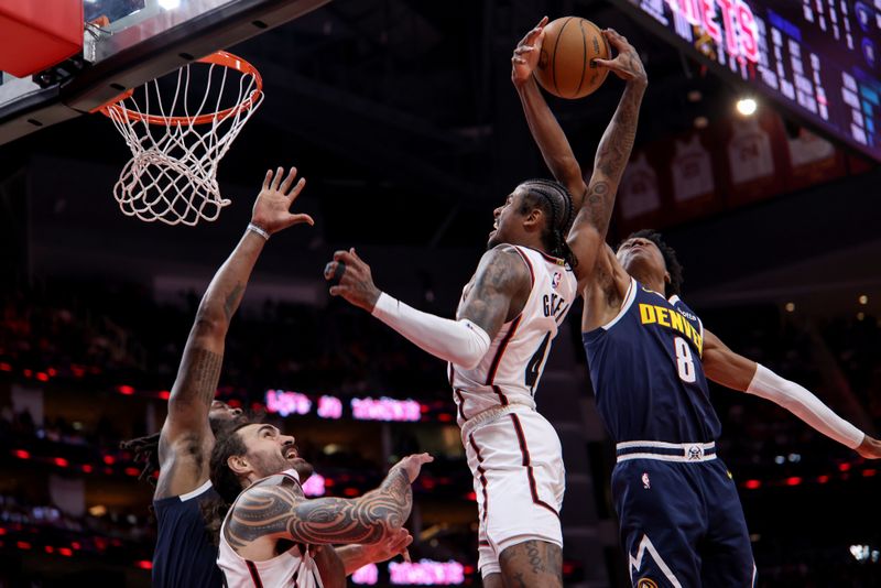 HOUSTON, TEXAS - MARCH 23: Jalen Green #4 of the Houston Rockets goes up for a dunk against Peyton Watson #8 of the Denver Nuggets in the second half at Toyota Center on March 23, 2025 in Houston, Texas.  NOTE TO USER: User expressly acknowledges and agrees that, by downloading and/or using this photograph, user is consenting to the terms and conditions of the Getty Images License Agreement.  (Photo by Tim Warner/Getty Images)