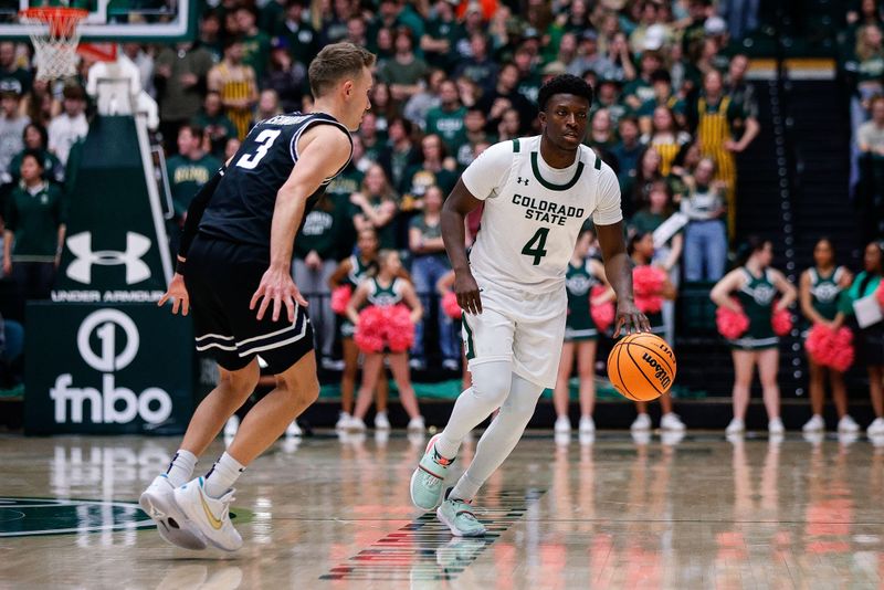 Feb 4, 2023; Fort Collins, Colorado, USA; Colorado State Rams guard Isaiah Stevens (4) dribbles the ball up court against Utah State Aggies guard Steven Ashworth (3) in the second half at Moby Arena. Mandatory Credit: Isaiah J. Downing-USA TODAY Sports