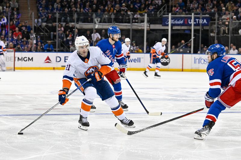 Apr 13, 2024; New York, New York, USA;  New York Islanders center Kyle Palmieri (21) skates with the puck defended by New York Rangers defenseman Ryan Lindgren (55) during the third period at Madison Square Garden. Mandatory Credit: Dennis Schneidler-USA TODAY Sports