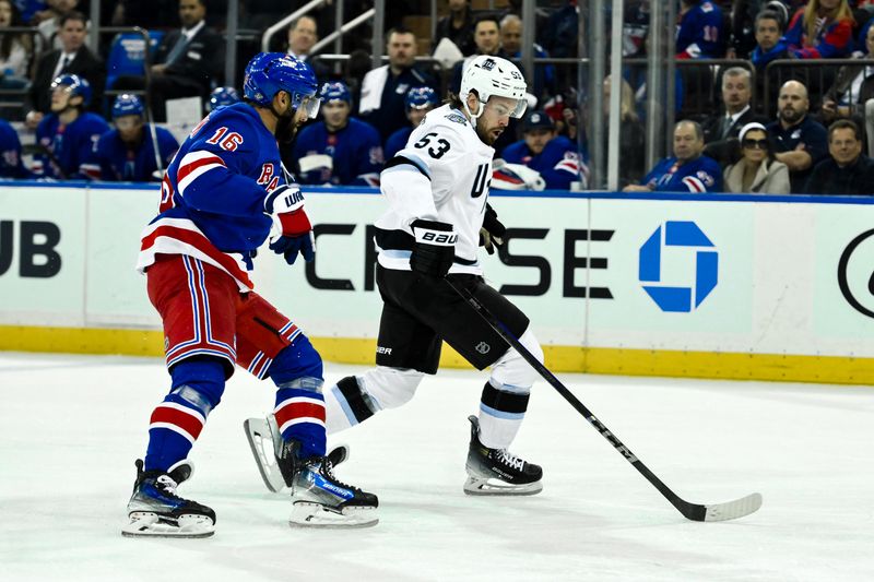 Oct 12, 2024; New York, New York, USA; Utah Hockey Club left wing Michael Carcone (53) skates with the puck against New York Rangers center Vincent Trocheck (16) during the third period at Madison Square Garden. Mandatory Credit: John Jones-Imagn Images