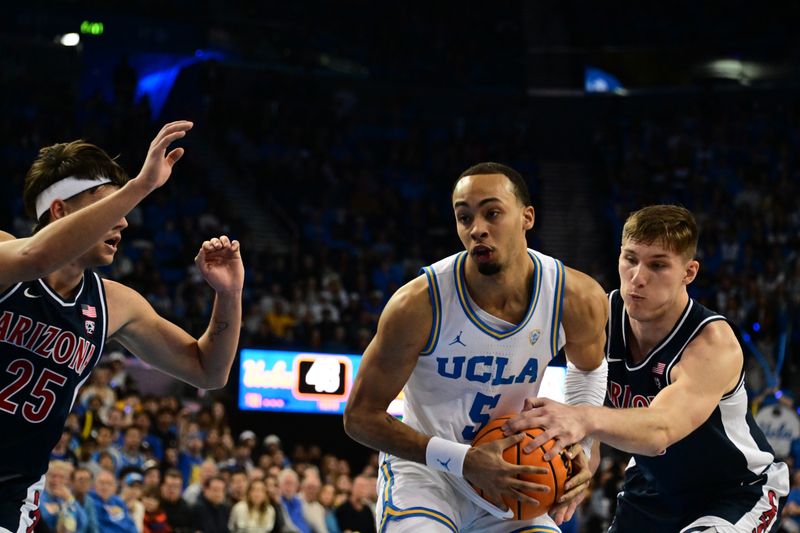 Mar 4, 2023; Los Angeles, California, USA;  UCLA Bruins guard Amari Bailey (5) drives to the basket as Arizona Wildcats guard Kerr Kriisa (25) defends during the second half at Pauley Pavilion presented by Wescom. Mandatory Credit: Richard Mackson-USA TODAY Sports