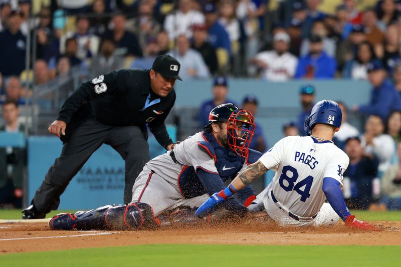 May 3, 2024; Los Angeles, California, USA;  Los Angeles Dodgers outfielder Andy Pages (84) is tagged out by Atlanta Braves catcher Travis d'Arnaud (16) in the second inning at Dodger Stadium. Mandatory Credit: Kiyoshi Mio-USA TODAY Sports