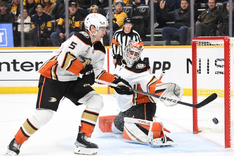 Jan 9, 2024; Nashville, Tennessee, USA; Anaheim Ducks goaltender Lukas Dostal (1) and defenseman Urho Vaakanainen (5) watch as the puck goes wide of the net at Bridgestone Arena. Mandatory Credit: Christopher Hanewinckel-USA TODAY Sports