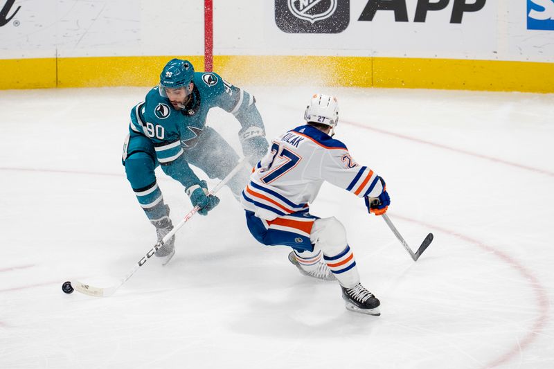 Dec 28, 2023; San Jose, California, USA; San Jose Sharks right wing Justin Bailey (90) skates with the puck against Edmonton Oilers left wing Warren Foegele (37) during the third period at SAP Center at San Jose. Mandatory Credit: Neville E. Guard-USA TODAY Sports