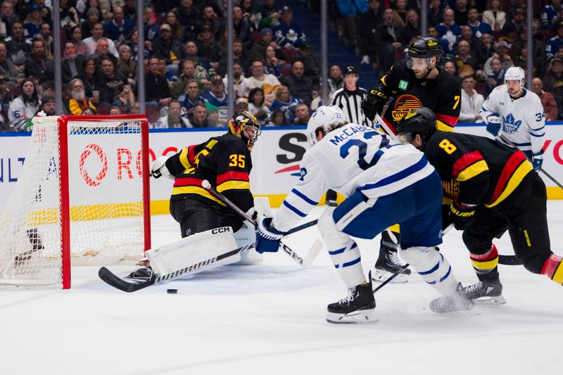 Jan 20, 2024; Vancouver, British Columbia, CAN; Toronto Maple Leafs defenseman Jake McCabe (22) scores on Vancouver Canucks goalie Thatcher Demko (35) in the second period at Rogers Arena. Mandatory Credit: Bob Frid-USA TODAY Sports