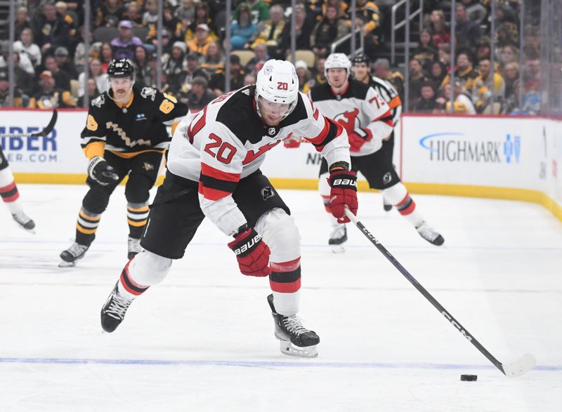 Nov 16, 2023; Pittsburgh, Pennsylvania, USA; New Jersey Devils center Michael McLeod (20) moves the puck against the Pittsburgh Penguins during the second period at PPG Paints Arena. Mandatory Credit: Philip G. Pavely-USA TODAY Sports