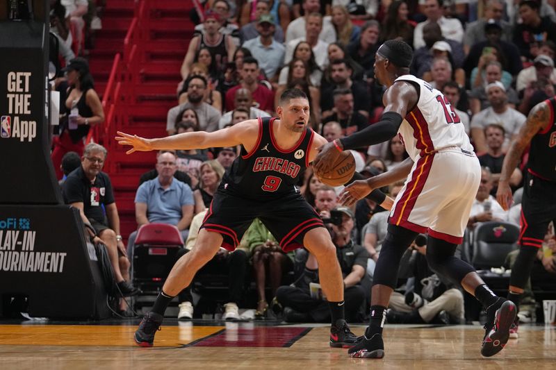 MIAMI, FL - APRIL 19: Nikola Vucevic #9 of the Chicago Bulls plays defense during the game against the Miami Heat during the 2024 SoFi Play-In Tournament on April 19, 2024 at Kaseya Center in Miami, Florida. NOTE TO USER: User expressly acknowledges and agrees that, by downloading and or using this Photograph, user is consenting to the terms and conditions of the Getty Images License Agreement. Mandatory Copyright Notice: Copyright 2024 NBAE (Photo by Eric Espada/NBAE via Getty Images)