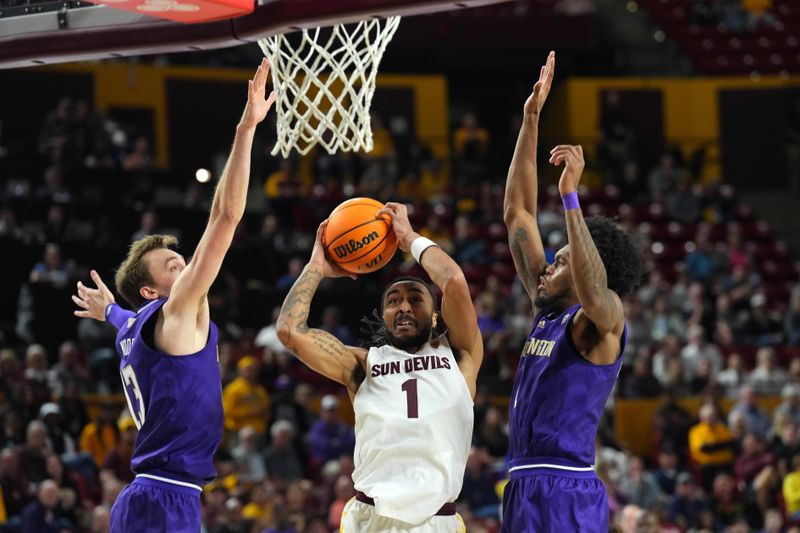 Feb 22, 2024; Tempe, Arizona, USA; Arizona State Sun Devils guard Frankie Collins (1) drives to the net against Washington Huskies forward Moses Wood (13) and Washington Huskies forward Keion Brooks Jr. (1) during the second half at Desert Financial Arena. Mandatory Credit: Joe Camporeale-USA TODAY Sports