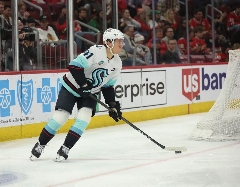 Mar 18, 2025; Chicago, Illinois, USA; Seattle Kraken defenseman Ryker Evans (41) skates with the puck during the third period against the Chicago Blackhawks at United Center. Mandatory Credit: Talia Sprague-Imagn Images