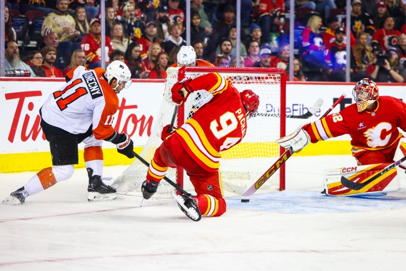 Oct 12, 2024; Calgary, Alberta, CAN; Calgary Flames goaltender Dustin Wolf (32) makes a save as Philadelphia Flyers right wing Travis Konecny (11) and Calgary Flames defenseman Brayden Pachal (94) battles for the puck during the third period at Scotiabank Saddledome. Mandatory Credit: Sergei Belski-Imagn Images