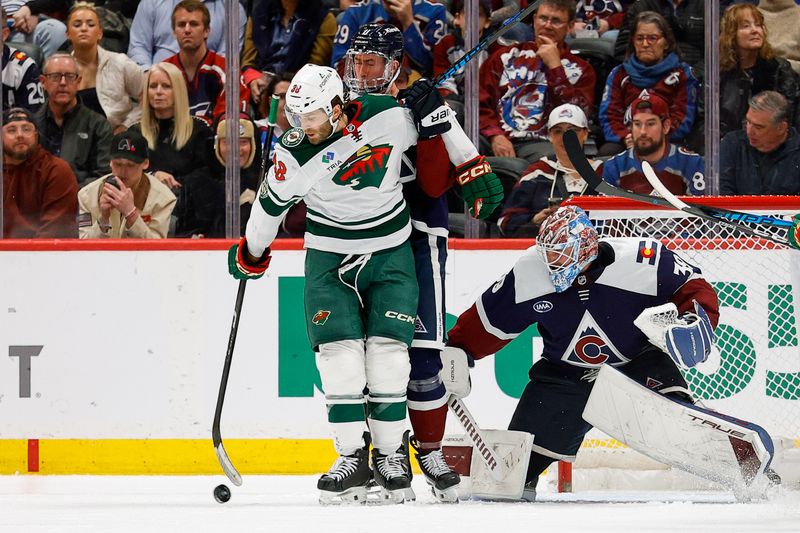 Feb 26, 2026; Denver, Colorado, USA; Minnesota Wild right wing Ryan Hartman (38) attempts to play the puck against Colorado Avalanche center Brock Nelson (11) as goaltender MacKenzie Blackwood (39) defends in the second period at Ball Arena. Mandatory Credit: Isaiah J. Downing-Imagn Images