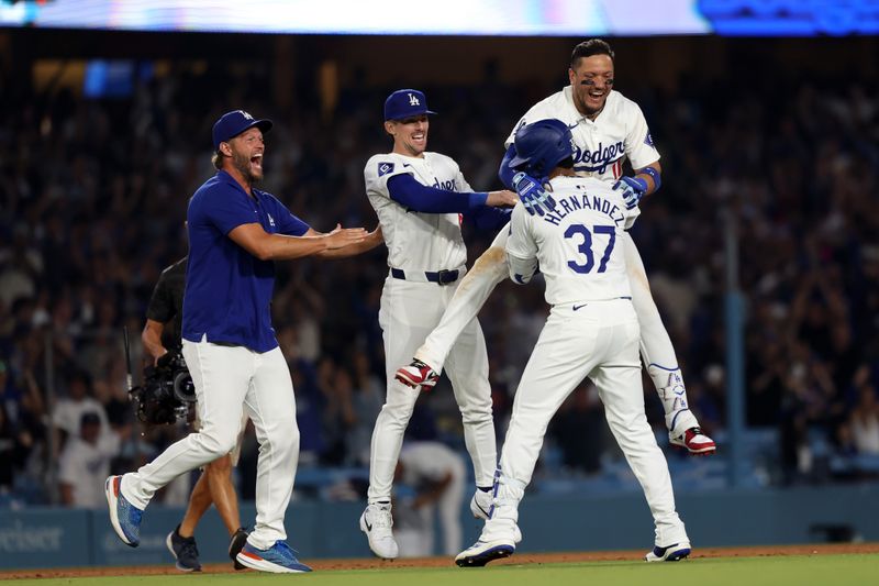 Jul 2, 2024; Los Angeles, California, USA;  Los Angeles Dodgers left fielder Teoscar Hernandez (37) celebrates with pitcher Clayton Kershaw (L) and second baseman Cavan Biggio (C) and shortstop Miguel Rojas (11) after hitting a walk off hit to defeat the Arizona Diamondbacks in bottom of the ninth inning at Dodger Stadium. Mandatory Credit: Kiyoshi Mio-USA TODAY Sports