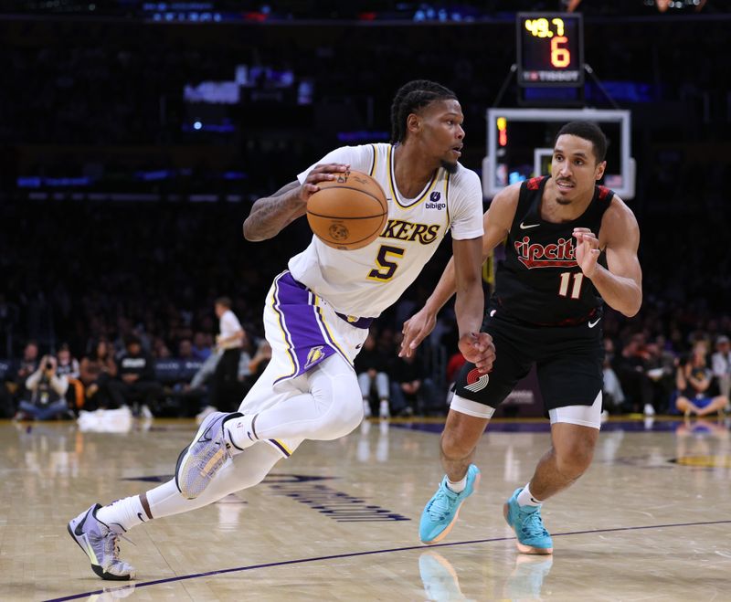 LOS ANGELES, CALIFORNIA - JANUARY 21: Cam Reddish #5 of the Los Angeles Lakers drives to the basket past Malcolm Brogdon #11 of the Portland Trail Blazers during a 134-110 win at Crypto.com Arena on January 21, 2024 in Los Angeles, California. User is consenting to the terms and conditions of the Getty Images License Agreement. (Photo by Harry How/Getty Images)