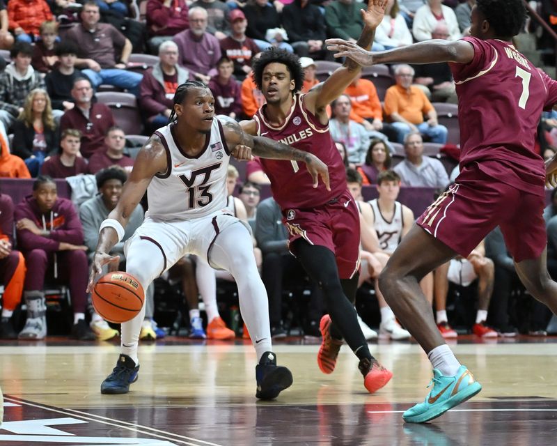 Feb 14, 2026; Blacksburg, Virginia, USA; Virginia Tech Hokies forward Amani Hansberry (13) drives the baseline defended by Florida State Seminoles guard Martin Somerville (1) during the second half at Cassell Coliseum. Mandatory Credit: Brian Bishop-Imagn Images