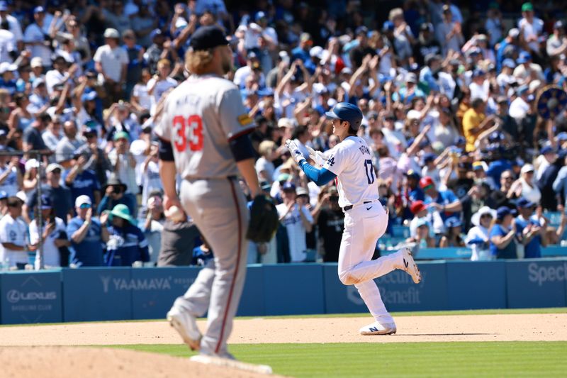 May 5, 2024; Los Angeles, California, USA;  Los Angeles Dodgers designated hitter Shohei Ohtani (17) hits a home run from Atlanta Braves pitcher A.J. Minter (33) during the eighth inning at Dodger Stadium. Mandatory Credit: Kiyoshi Mio-USA TODAY Sports