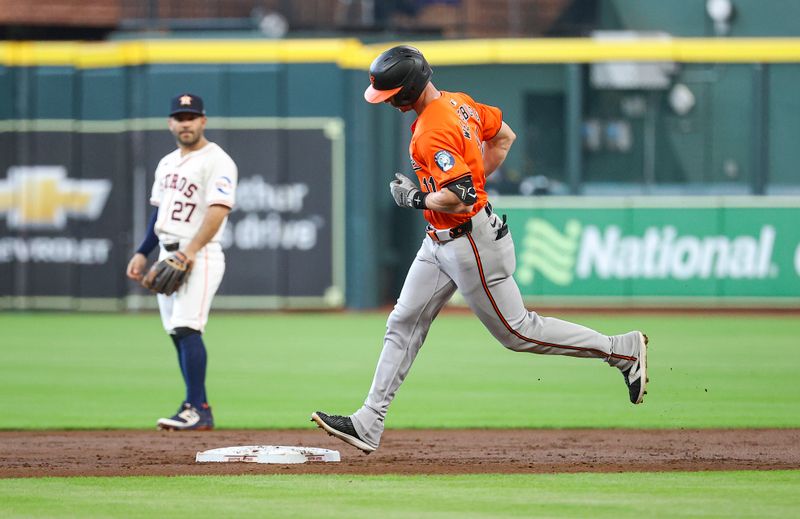 Jun 22, 2024; Houston, Texas, USA; Houston Astros second baseman Jose Altuve (27) looks on and Baltimore Orioles second baseman Jordan Westburg (11) rounds the bases after hitting a home run during the second inning at Minute Maid Park. Mandatory Credit: Troy Taormina-USA TODAY Sports