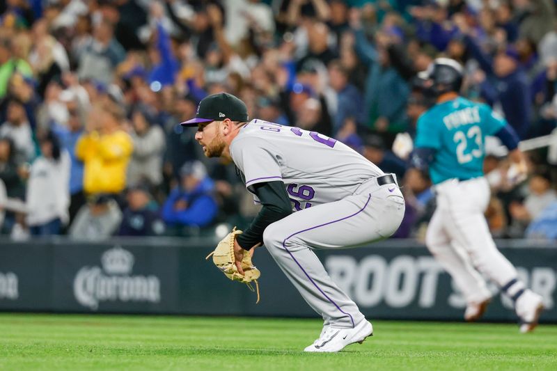 Apr 14, 2023; Seattle, Washington, USA; Colorado Rockies starting pitcher Austin Gomber (26) watches a two-run double by Seattle Mariners first baseman Ty France (background) during the fourth inning at T-Mobile Park. Mandatory Credit: Joe Nicholson-USA TODAY Sports