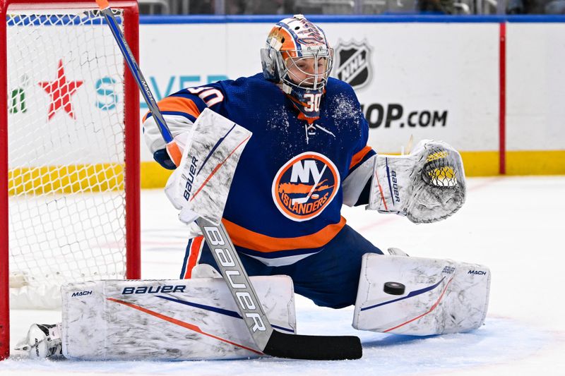 Apr 17, 2024; Elmont, New York, USA;  New York Islanders goaltender Ilya Sorokin (30) makes a save against the Pittsburgh Penguins during the first period at UBS Arena. Mandatory Credit: Dennis Schneidler-USA TODAY Sports