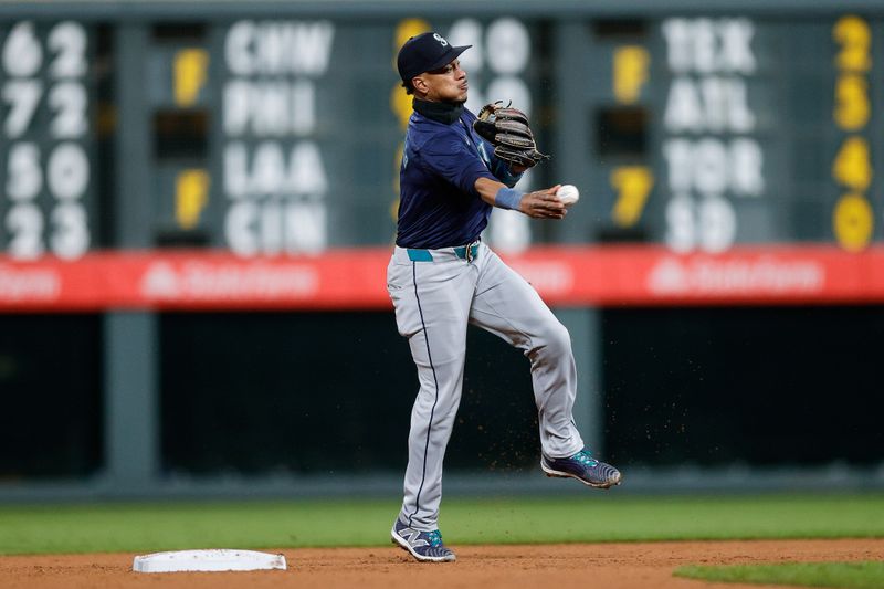 Apr 20, 2024; Denver, Colorado, USA; Seattle Mariners second baseman Jorge Polanco (7) throws to first for an out in the ninth inning against the Colorado Rockies at Coors Field. Mandatory Credit: Isaiah J. Downing-USA TODAY Sports