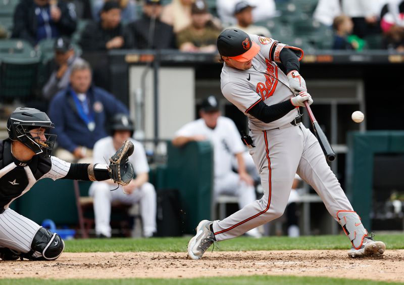 May 26, 2024; Chicago, Illinois, USA; Baltimore Orioles catcher Adley Rutschman (35) hits a two-run home run against the Chicago White Sox during the sixth inning at Guaranteed Rate Field. Mandatory Credit: Kamil Krzaczynski-USA TODAY Sports