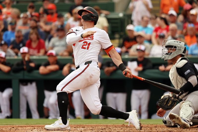 Mar 2, 2024; Sarasota, Florida, USA; Baltimore Orioles left fielder Austin Hays (21) hits a home run during the fifth inning against the New York Yankees at Ed Smith Stadium. Mandatory Credit: Kim Klement Neitzel-USA TODAY Sports