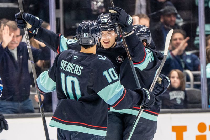 Mar 16, 2025; Seattle, Washington, USA;  Seattle Kraken foward Jani Nyman (38), center, celebrates scoring a goal with forward Matty Beniers (10) and defenseman Brandon Montour (62) during the first period against the Winnipeg Jets at Climate Pledge Arena. Mandatory Credit: Stephen Brashear-Imagn Images