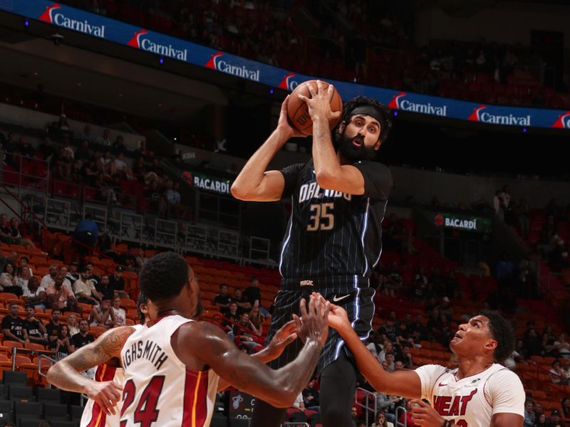 MIAMI, FL - OCTOBER 23: Goga Bitadze #35 of the Orlando Magic goes up for the rebound during the game against the Miami Heat on October 23, 2024 at Kaseya Center in Miami, Florida. NOTE TO USER: User expressly acknowledges and agrees that, by downloading and or using this Photograph, user is consenting to the terms and conditions of the Getty Images License Agreement. Mandatory Copyright Notice: Copyright 2024 NBAE (Photo by Issac Baldizon/NBAE via Getty Images)