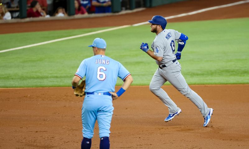 Jul 23, 2023; Arlington, Texas, USA;  Los Angeles Dodgers third baseman Max Muncy (13) celebrates past  Texas Rangers third baseman Josh Jung (6) after hitting a grand slam during the first inning at Globe Life Field. Mandatory Credit: Kevin Jairaj-USA TODAY Sports