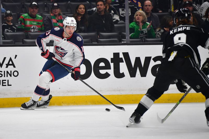 Mar 16, 2023; Los Angeles, California, USA; Columbus Blue Jackets center Liam Foudy (19) moves the puck against Los Angeles Kings right wing Adrian Kempe (9) during the first period at Crypto.com Arena. Mandatory Credit: Gary A. Vasquez-USA TODAY Sports