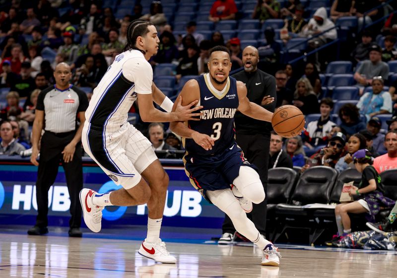 NEW ORLEANS, LOUISIANA - MARCH 13: CJ McCollum #3 of the New Orleans Pelicans drives past Anthony Black #0 of the Orlando Magic during the second half of a game at the Smoothie King Center on March 13, 2025 in New Orleans, Louisiana. NOTE TO USER: User expressly acknowledges and agrees that, by downloading and or using this photograph, User is consenting to the terms and conditions of the Getty Images License Agreement. (Photo by Derick E. Hingle/Getty Images)
