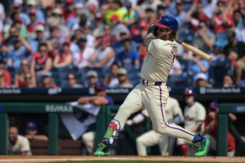 Jun 22, 2024; Philadelphia, Pennsylvania, USA;  Philadelphia Phillies first base Bryce Harper (3) hits an RBI single in the first inning against the Arizona Diamondbacks at Citizens Bank Park. Mandatory Credit: John Geliebter-USA TODAY Sports