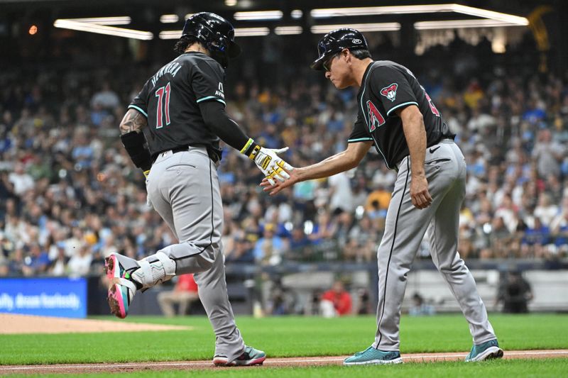 Sep 21, 2024; Milwaukee, Wisconsin, USA; Arizona Diamondbacks catcher Jose Herrera (11) is congratulated by Arizona Diamondbacks third base coach Tony Perezchica (21) after hitting a home run against the Milwaukee Brewers in the fifth inning  at American Family Field. Mandatory Credit: Michael McLoone-Imagn Images