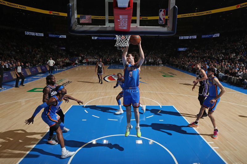 OKLAHOMA CITY, OK - APRIL 9: Josh Giddey #3 of the Oklahoma City Thunder grabs a rebound during the game against the Sacramento Kings  on April 9, 2024 at Paycom Arena in Oklahoma City, Oklahoma. NOTE TO USER: User expressly acknowledges and agrees that, by downloading and or using this photograph, User is consenting to the terms and conditions of the Getty Images License Agreement. Mandatory Copyright Notice: Copyright 2024 NBAE (Photo by Zach Beeker/NBAE via Getty Images)