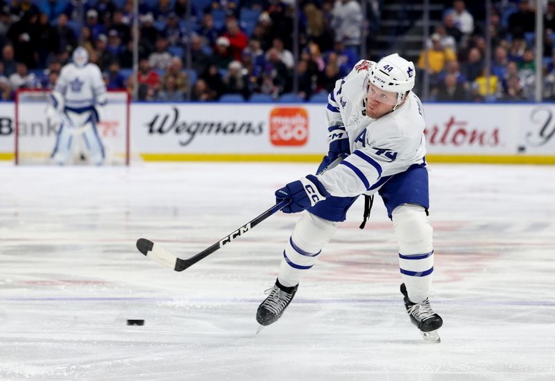 Dec 21, 2023; Buffalo, New York, USA;  Toronto Maple Leafs defenseman Morgan Rielly (44) takes a shot on goal during the first period against the Buffalo Sabres at KeyBank Center. Mandatory Credit: Timothy T. Ludwig-USA TODAY Sports