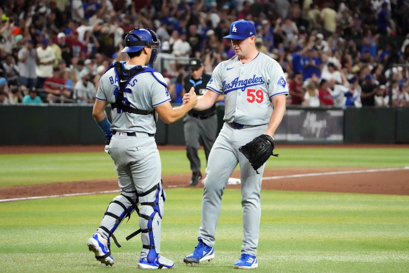 Aug 31, 2024; Phoenix, Arizona, USA; Los Angeles Dodgers catcher Will Smith (16) and Los Angeles Dodgers pitcher Evan Phillips (59) celebrate after the ninth inning against the Arizona Diamondbacks at Chase Field. Mandatory Credit: Joe Camporeale-USA TODAY Sports