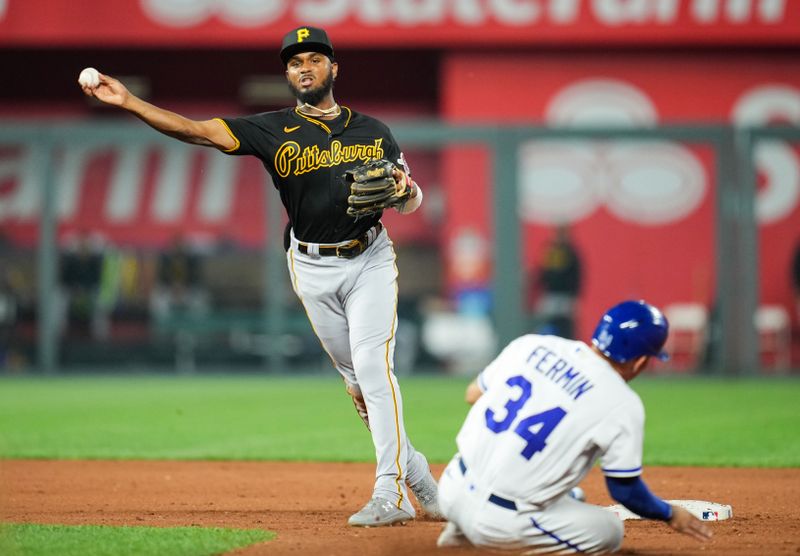 Aug 30, 2023; Kansas City, Missouri, USA; Pittsburgh Pirates second baseman Liover Peguero (60) throws to first base after forcing out Kansas City Royals catcher Freddy Fermin (34) during the fifth inning at Kauffman Stadium. Mandatory Credit: Jay Biggerstaff-USA TODAY Sports