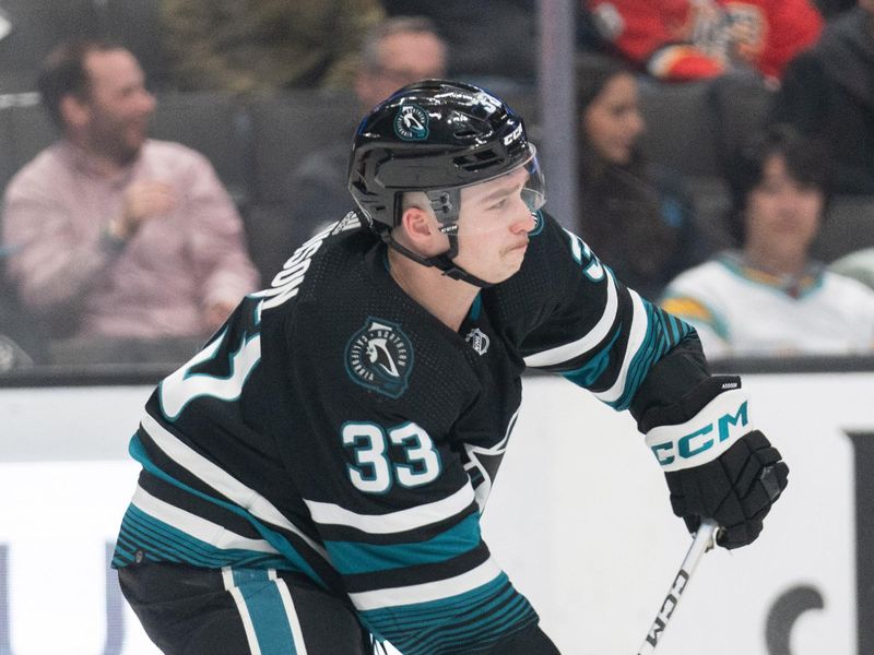 Mar 7, 2024; San Jose, California, USA; San Jose Sharks defenseman Calen Addison (33) passes the puck during the third period against the New York Islanders at SAP Center at San Jose. Mandatory Credit: Stan Szeto-USA TODAY Sports