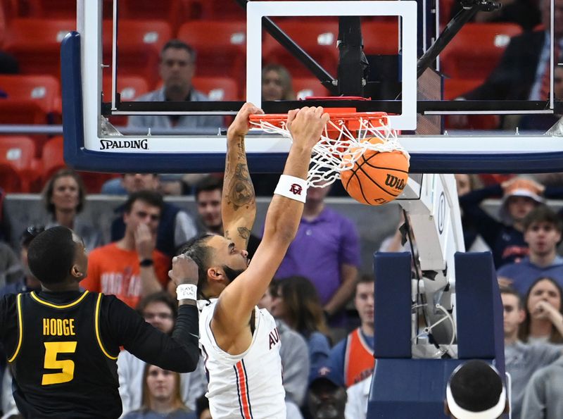 Feb 14, 2023; Auburn, Alabama, USA; Auburn Tigers forward Johni Broome (4) dunks the ball over Missouri Tigers guard D'Moi Hodge (5) during the first half at Neville Arena. Mandatory Credit: Julie Bennett-USA TODAY Sports